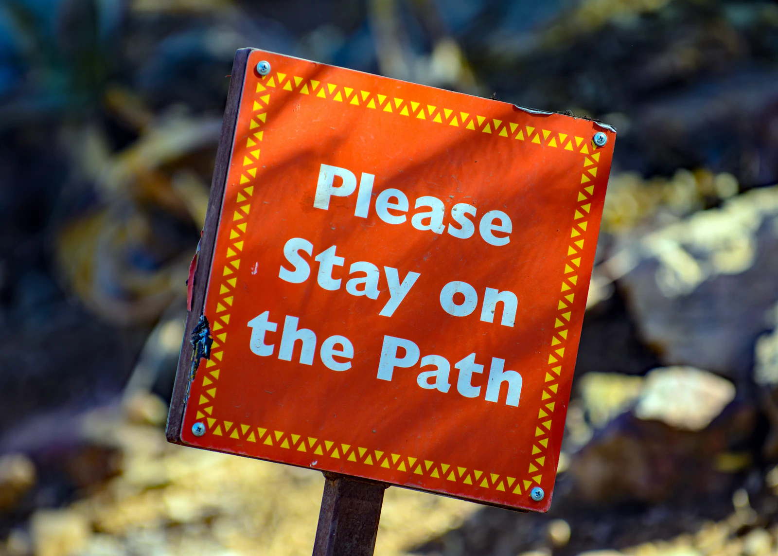 Sign saying 'please stay on the path'